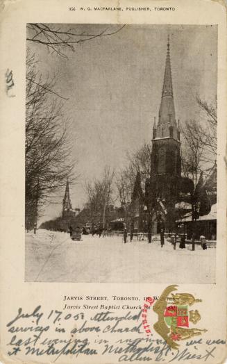 Black and white photograph of a city street bordered by churches and trees. The ground is cover ...