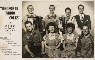 Black and white photograph of a eight people in a country style band posing for a group shot.