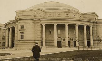 Black and white photograph of a large Beaux-Arts building with a domed roof.