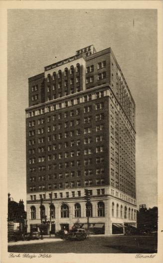 B/W photo postcard depicting the exterior corner-view of a building with caption at the bottom  ...