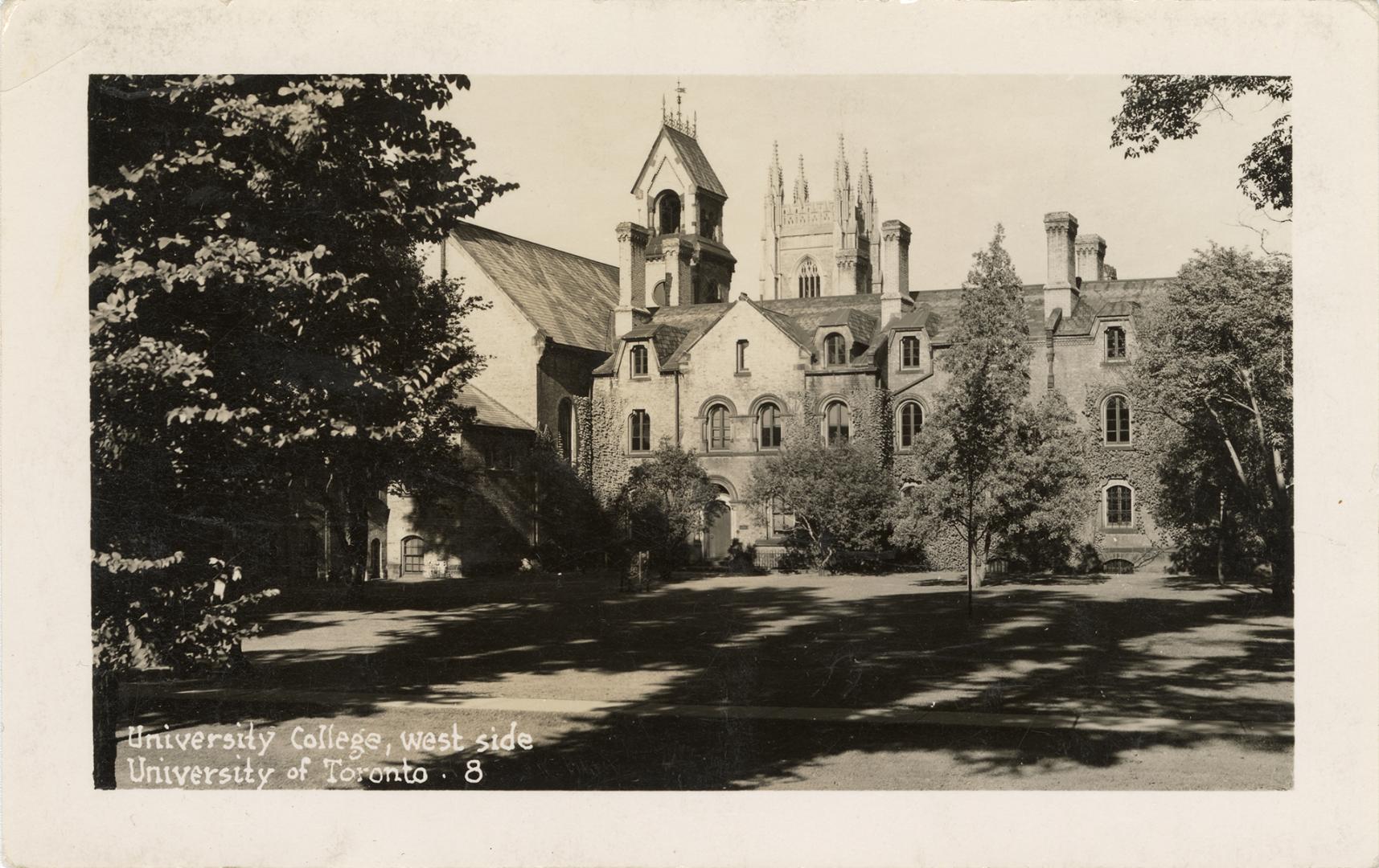 Black and white photograph of a very large stone building with many towers.