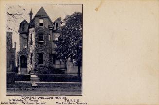 Black and white photograph of a three story annex style house.