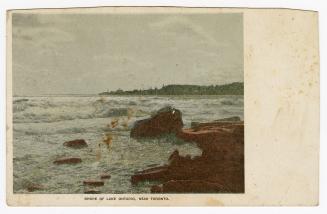 Colorized photograph of waves crashing up against rocks.