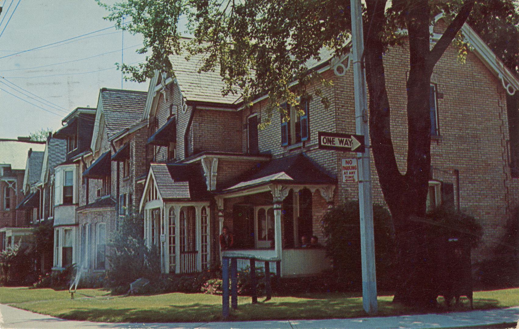 Colour photograph of a row of brick houses.