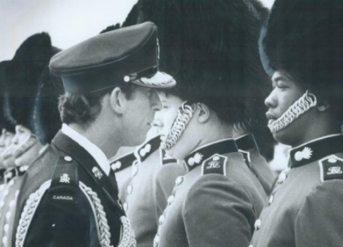 A young King Charles in front of Canadian military officers